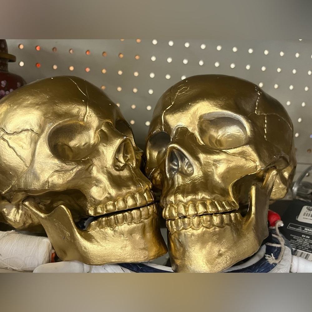 Two gold skulls